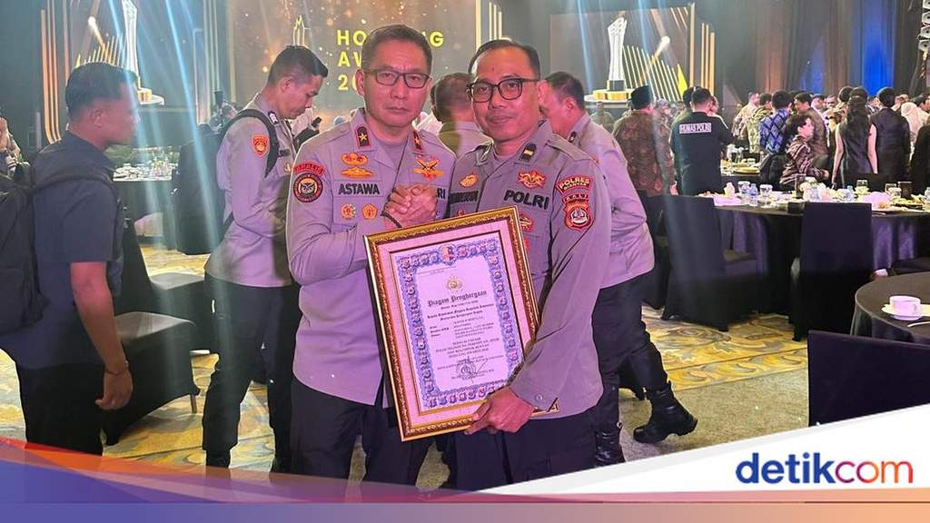 Balinese police officer standing proudly representing community dedication