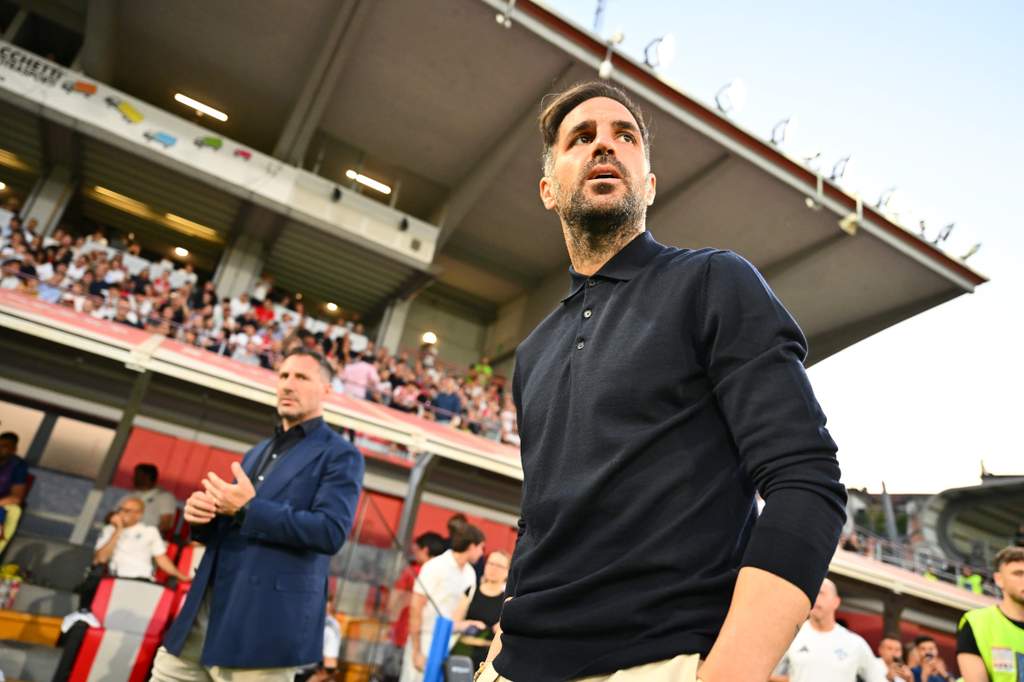 Como coach Cesc Fabregas standing on the touchline during a match