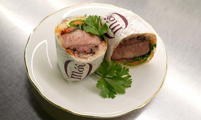 Chef Peter Cuong Franklin presenting a gourmet banh mi at Anan Saigon restaurant