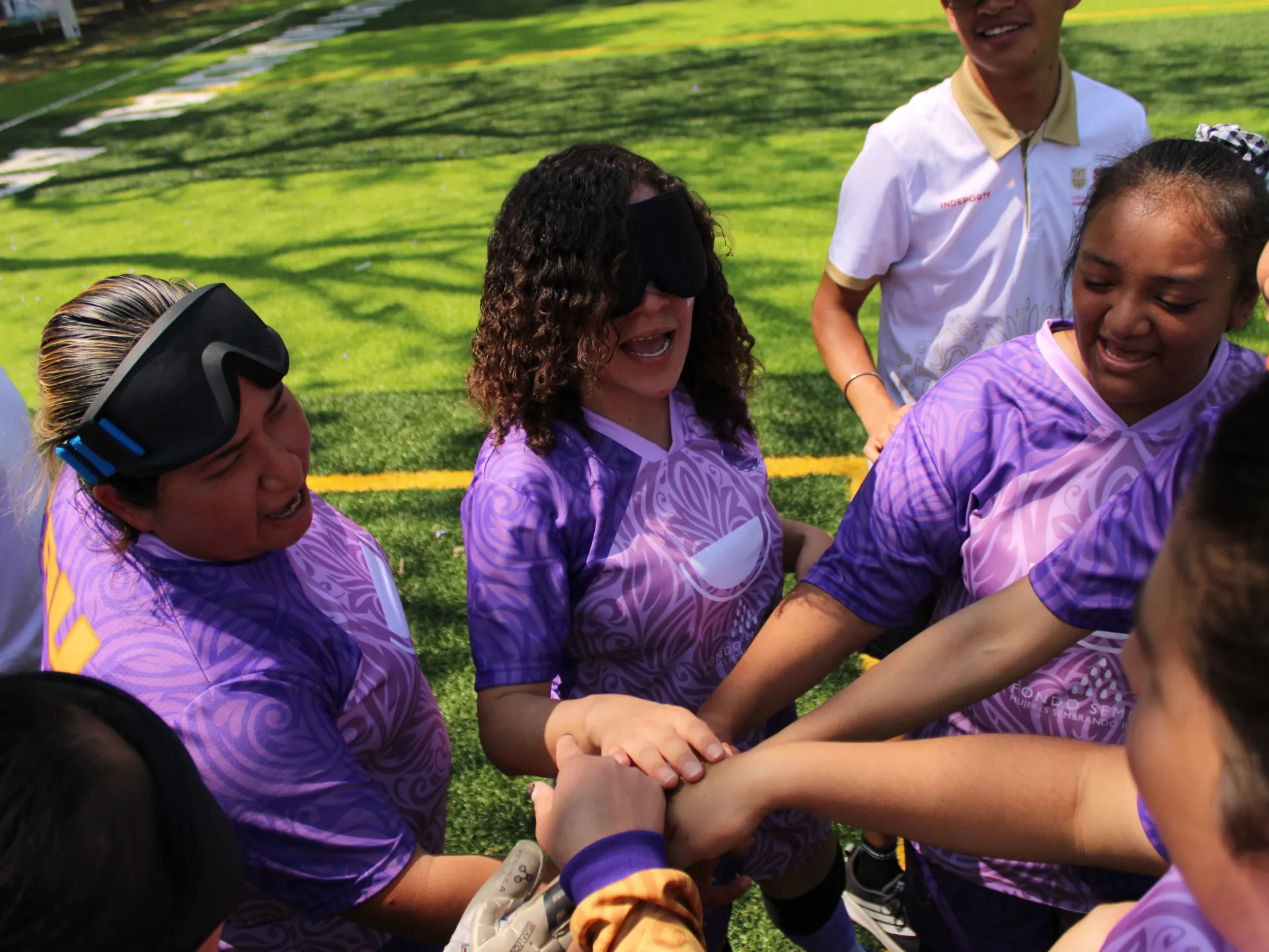 Blind football players preparing for training session with eye masks