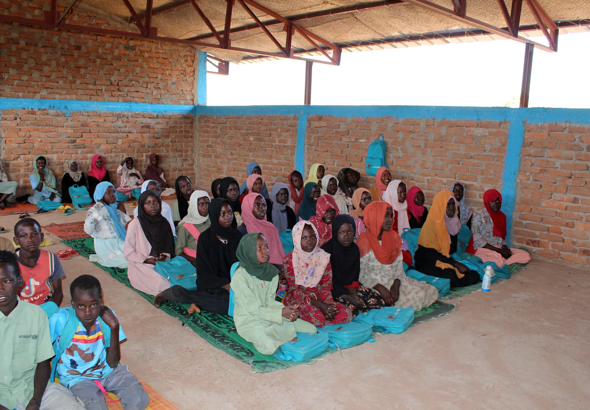 Sudanese refugee children attending a makeshift primary school class in an eastern Chadian refugee camp
