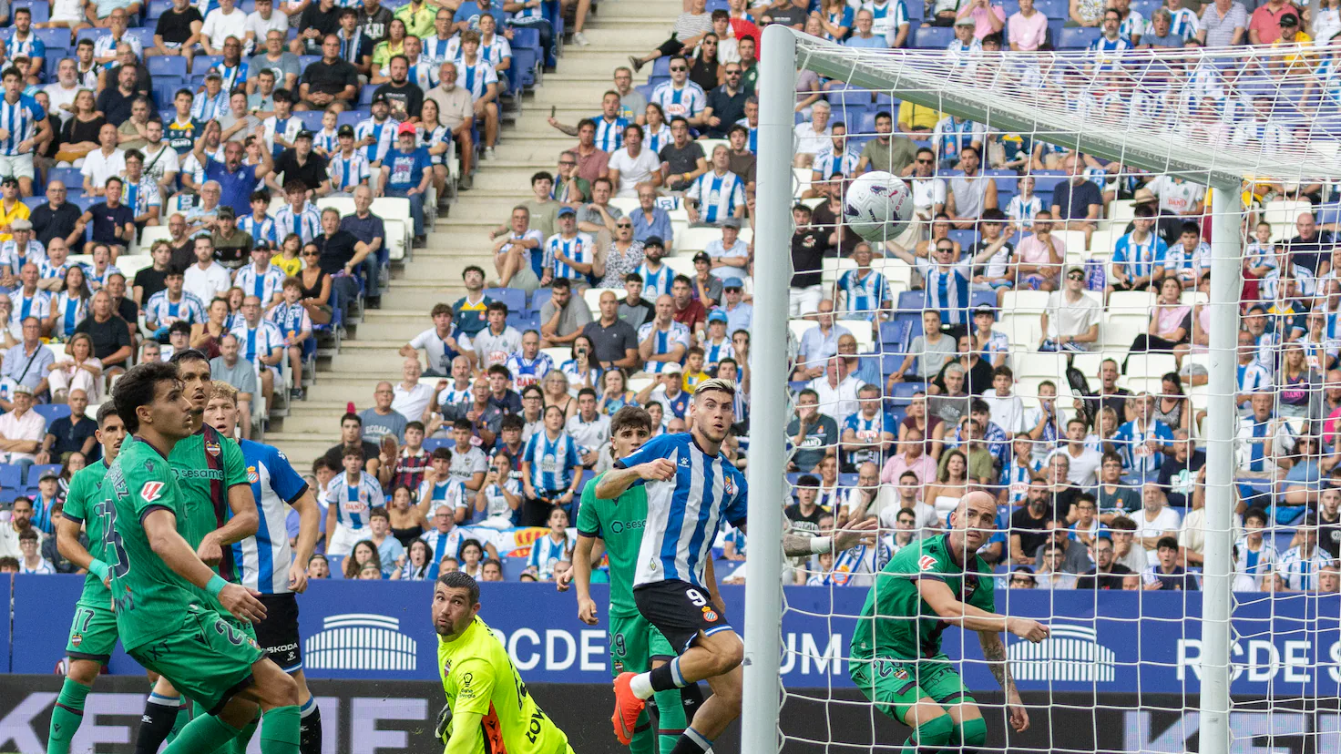 Football players competing intensely on the pitch during a La Liga match at RCDE Stadium