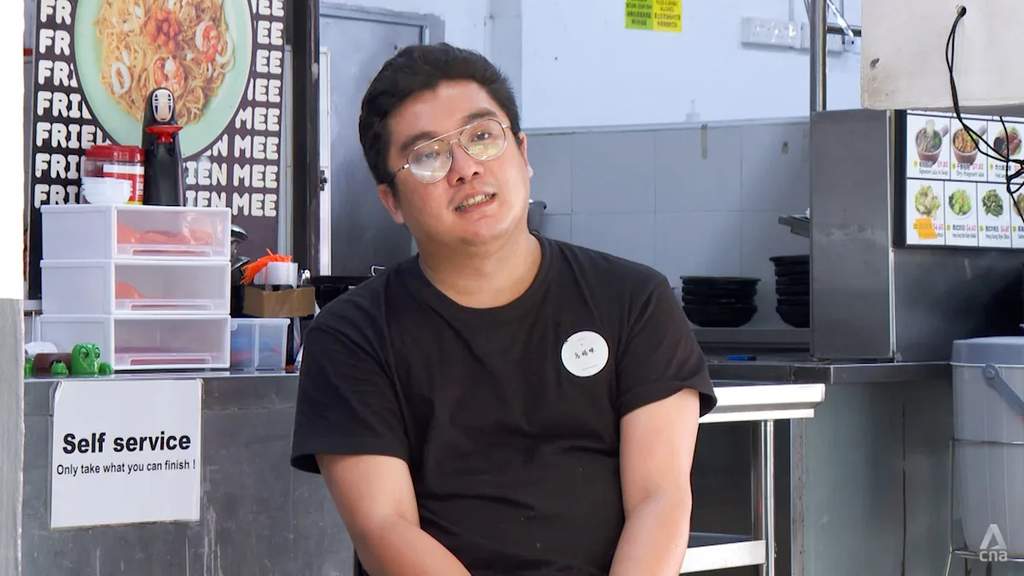 Alvin Tan standing in front of his Hokkien mee stall