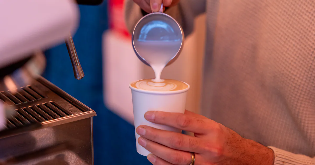 A fresh cup of coffee on a wooden table representing daily wellness benefits.