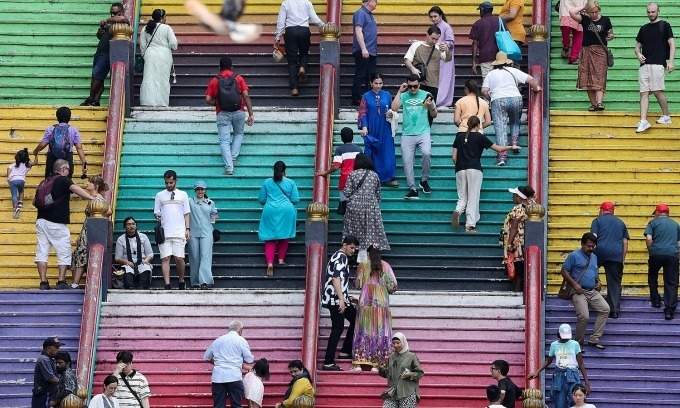 Tourists walking up the stairs at Batu Caves in Malaysia