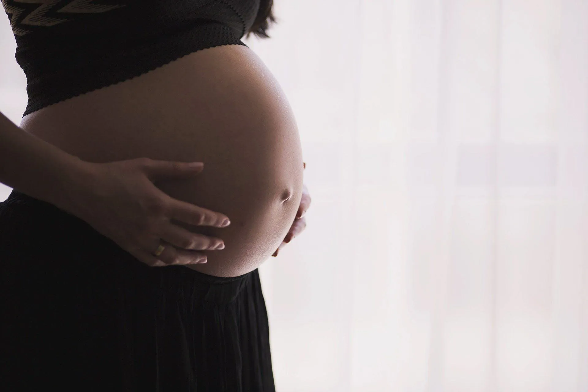 Medical professionals discussing high risk pregnancy care in a hospital setting