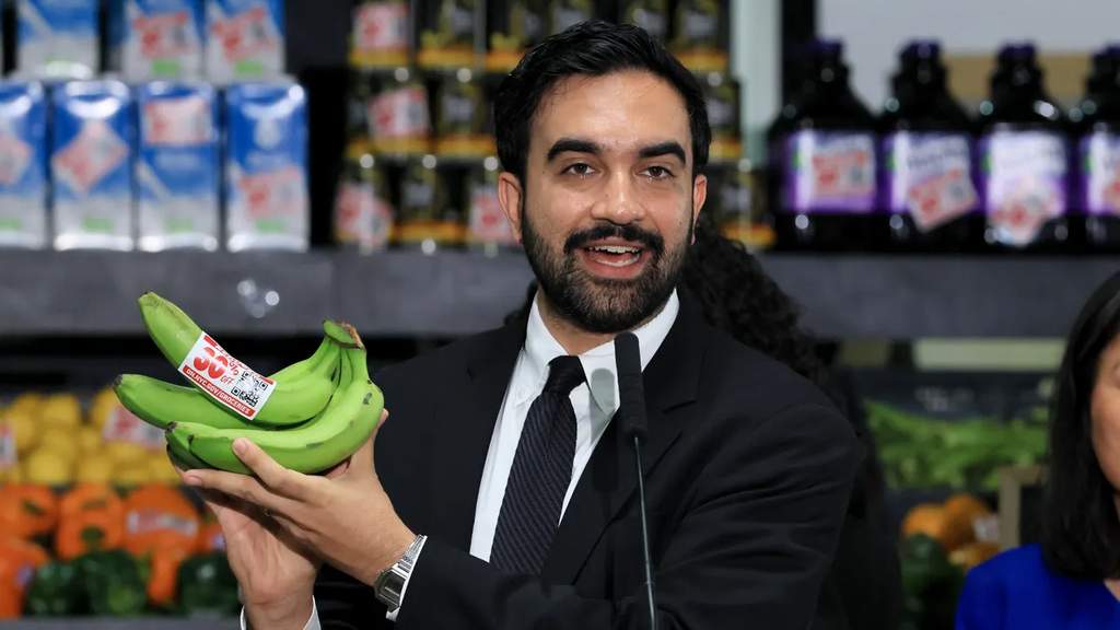 New York City Mayor Zohran Mamdani holding bananas at a food distribution center