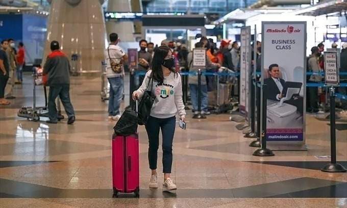 Traveler walking through Kuala Lumpur International Airport terminal building