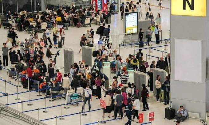Travelers waiting to check in for flights at Suvarnabhumi airport in Bangkok, Thailand