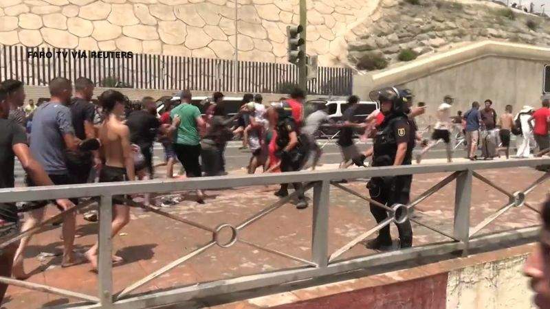 Crowds of migrants walking near the border in Ceuta