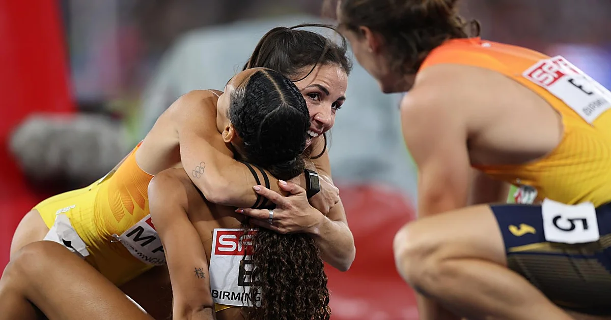 Spanish athletes celebrating on the track after winning a relay medal