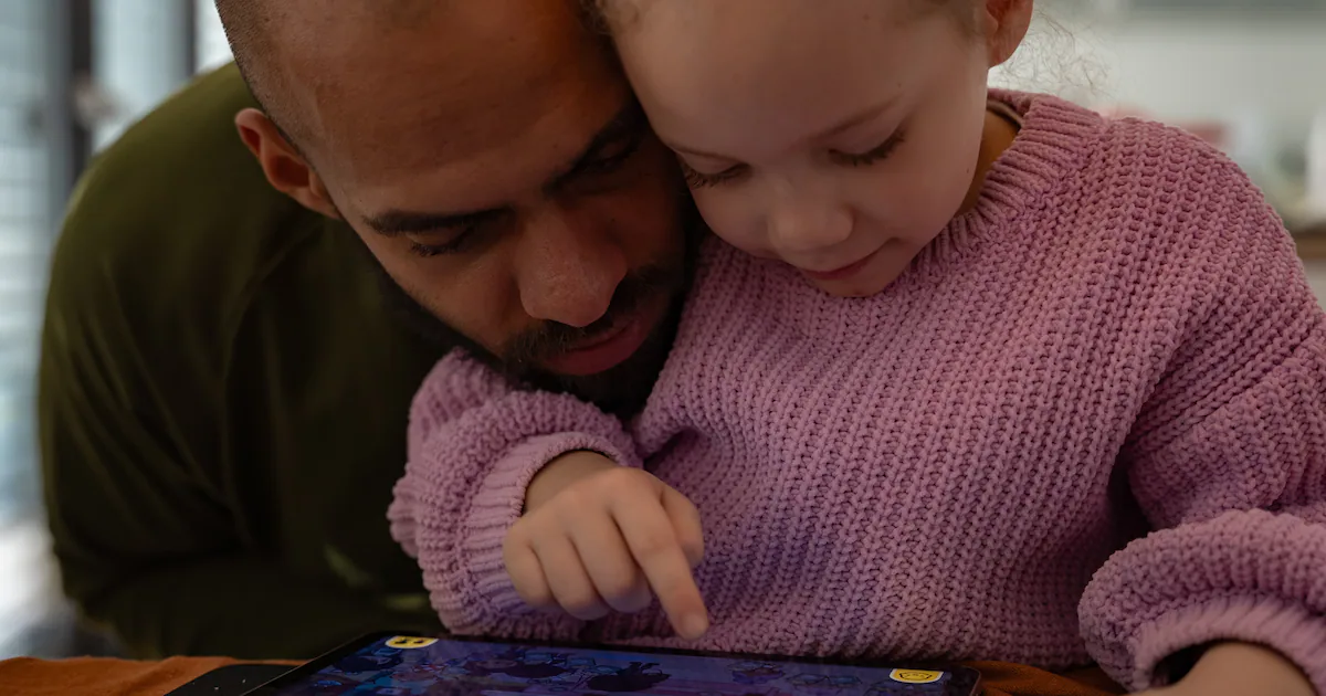 Young children using digital tablets at home for interactive learning and games