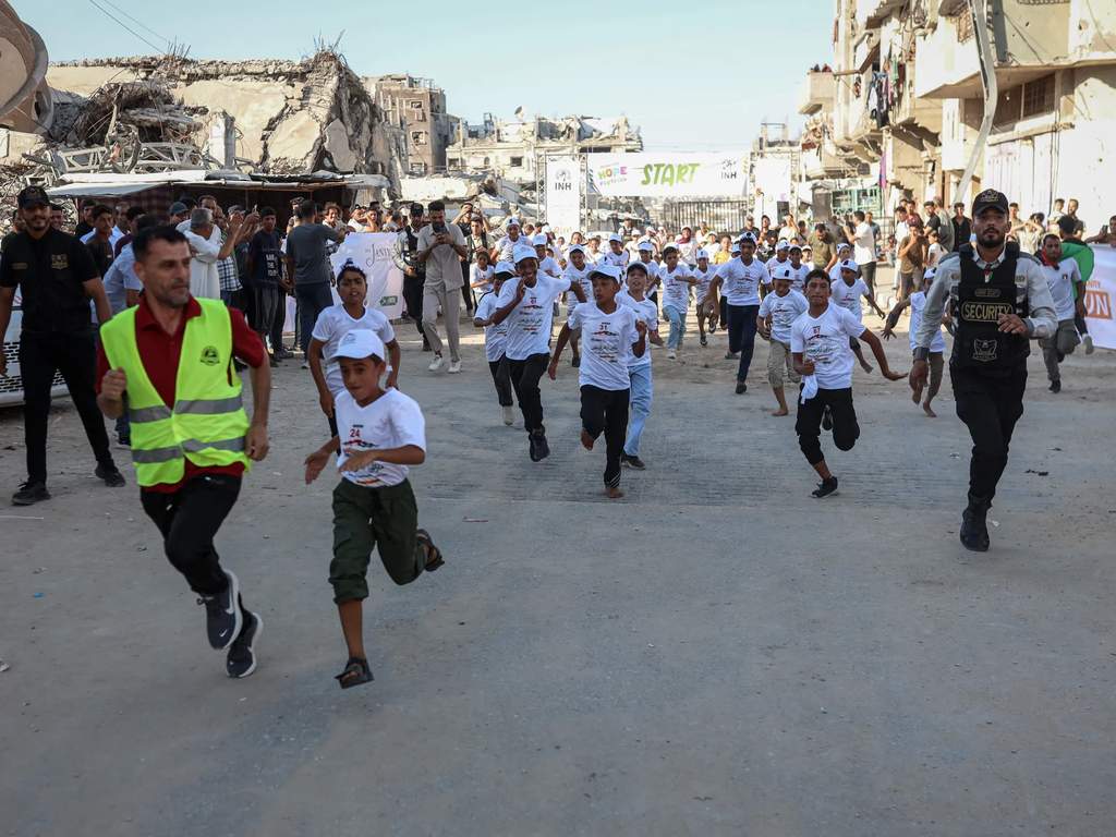 Young boys and girls participating in a running event in Khan Younis