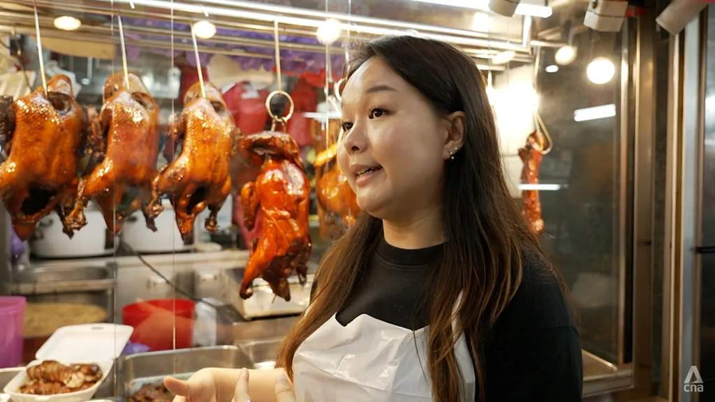 Young woman working at a traditional Singaporean roast meat shop